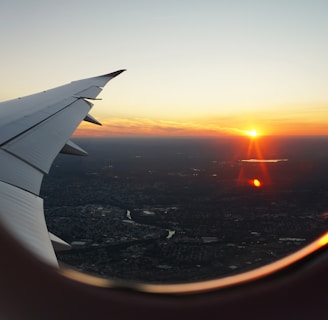 airplanes window view of sky during golden hour