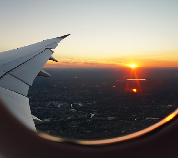 airplanes window view of sky during golden hour