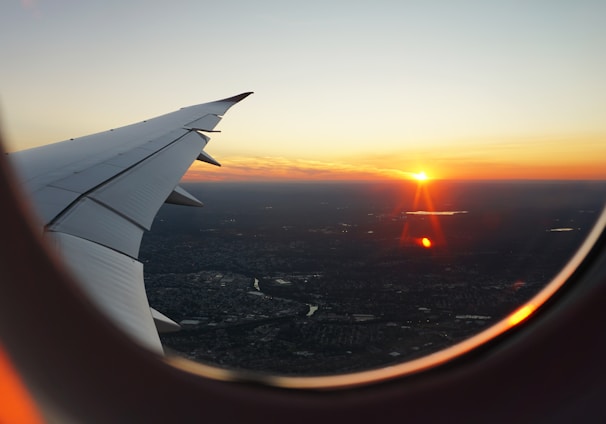 airplanes window view of sky during golden hour