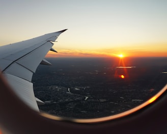 airplanes window view of sky during golden hour