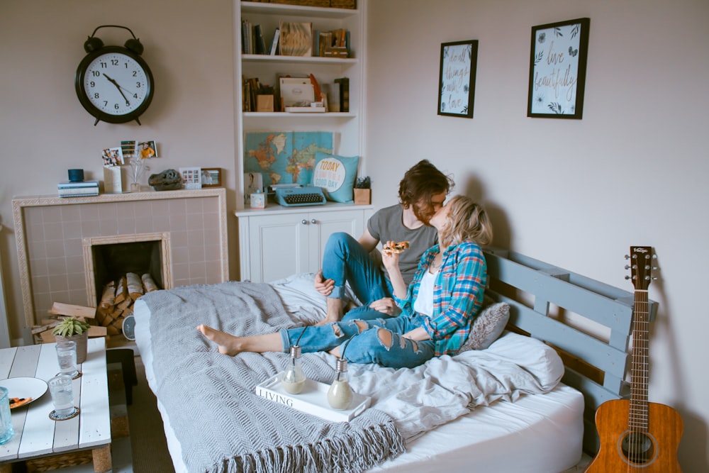 man and woman kissing on bed