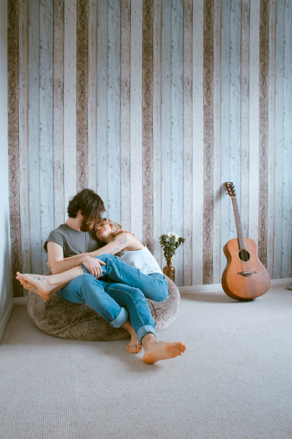 man and woman sitting on gray beanbag