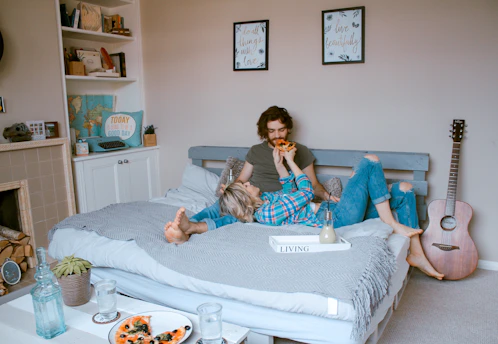 man and woman lying on bed