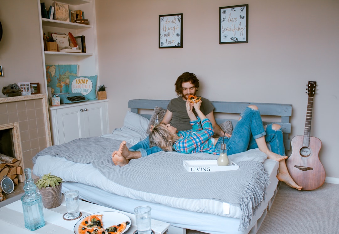  man and woman lying on bed double bed