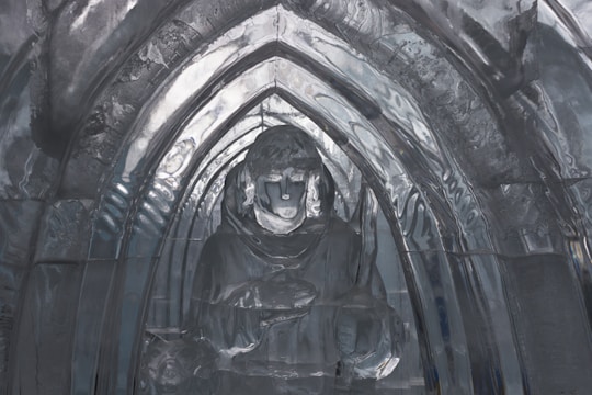 Elegant ice sculpture featuring intricate details displayed at a corporate gala.