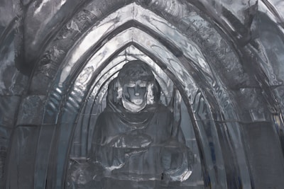 A close-up of ice blocks being carved by skilled artisans, highlighting the craftsmanship involved.