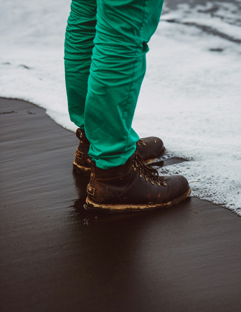 person standing on seashore during daytime