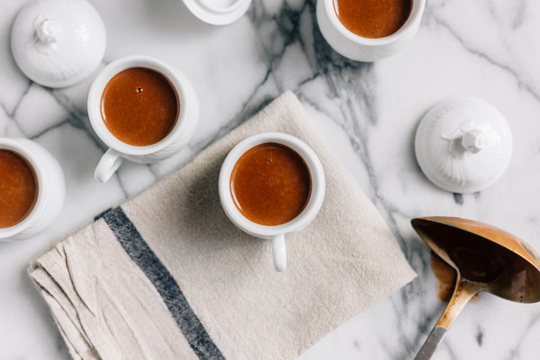 Before putting into the oven, the chocolate mixture is poured carefully into specially made porcelain cups used to cook, serve, and present a pot de crème.