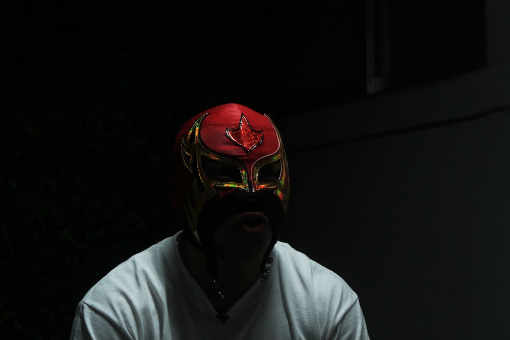 homme portant un masque rouge et une chemise blanche