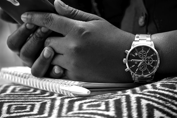 Close-up of hands holding a medical appointment schedule.