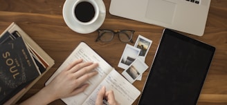 person holding ballpoint pen writing on notebook