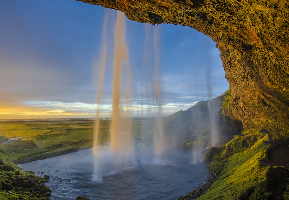 waterfalls under blue skies