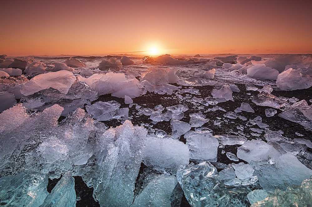 floating ice on ocean during sunset