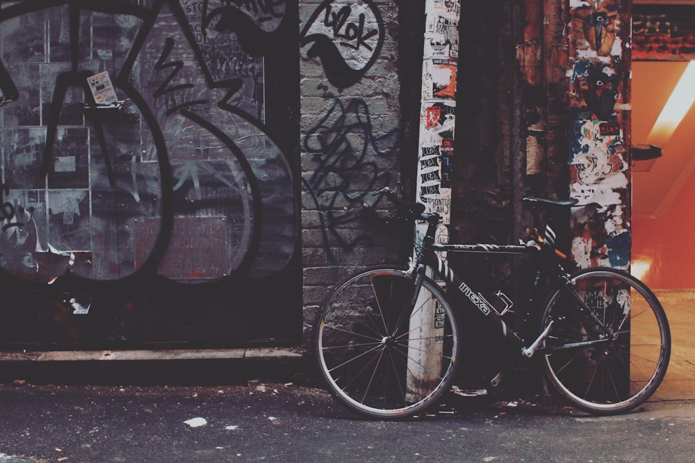 black bicycle near post