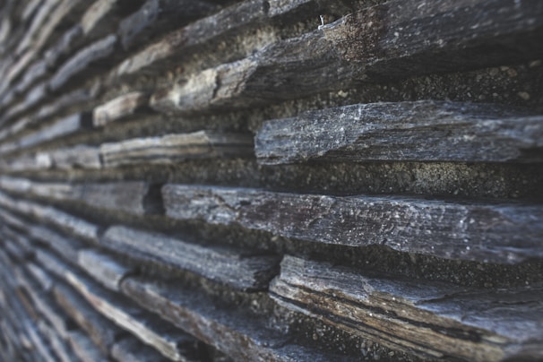 Close-up of rough-cut stone wall highlighting unique textures and colors.