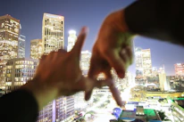 Professional handshake between business partners near a city skyline.