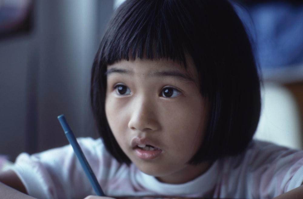 girl holding pen