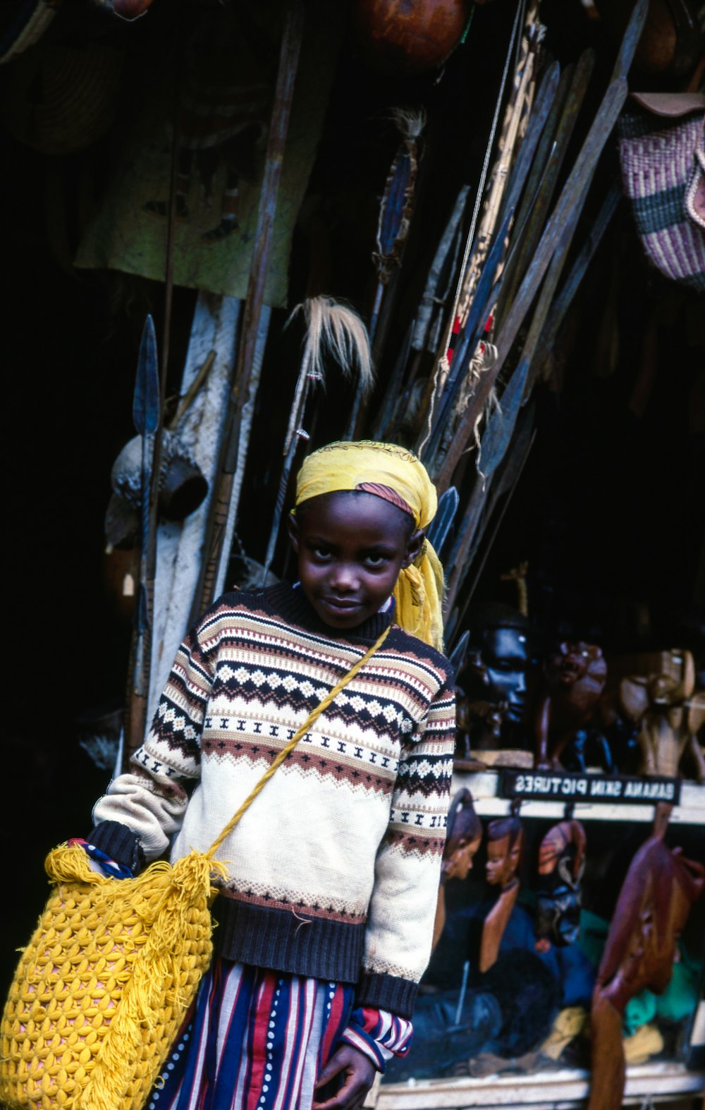 boy carrying yellow knitted bag