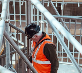man standing under scaffoldings