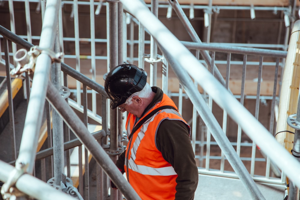 man standing under scaffoldings