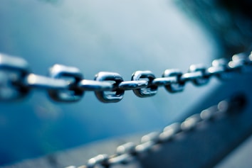 tilt shift lens photo of stainless steel chain