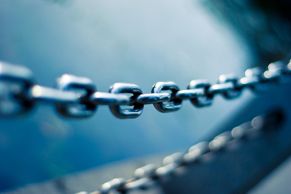 tilt shift lens photo of stainless steel chain