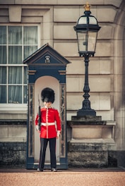A British security officer in uniform standing confidently at a busy UK event entrance.