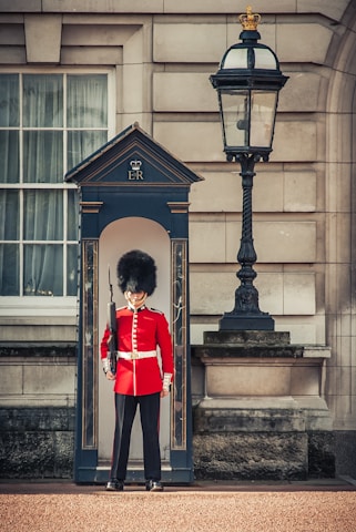 A British security officer in uniform standing confidently at a busy UK event entrance.