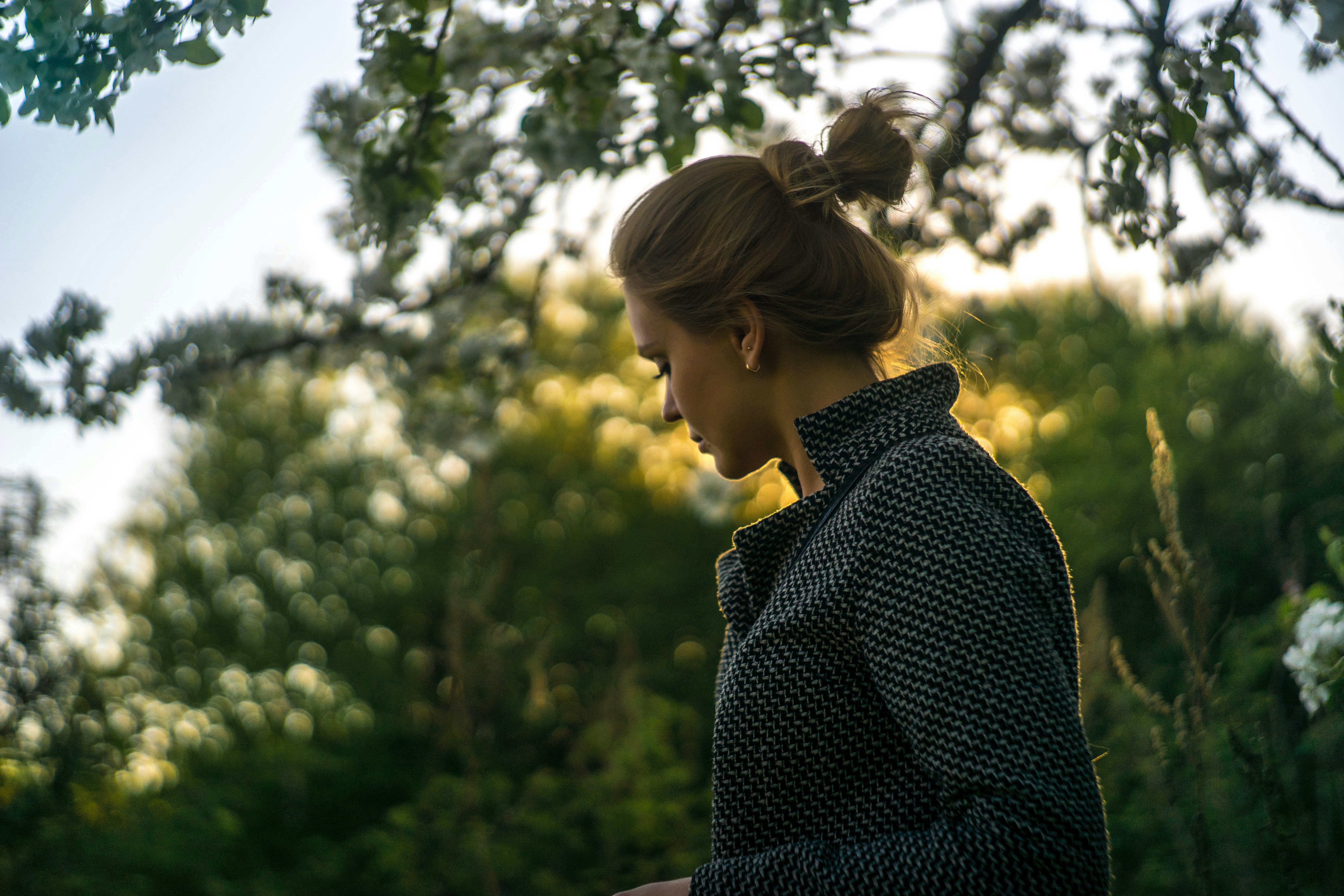 Woman in a bun looking down