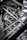 Intricate steel beams and trusses form a complex lattice structure, showcasing industrial design and engineering. The interlocking metal components create geometric patterns with rivets visible throughout the structure.