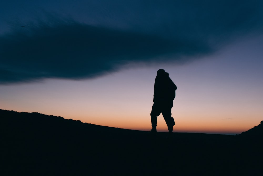 silhouette photo of person walking