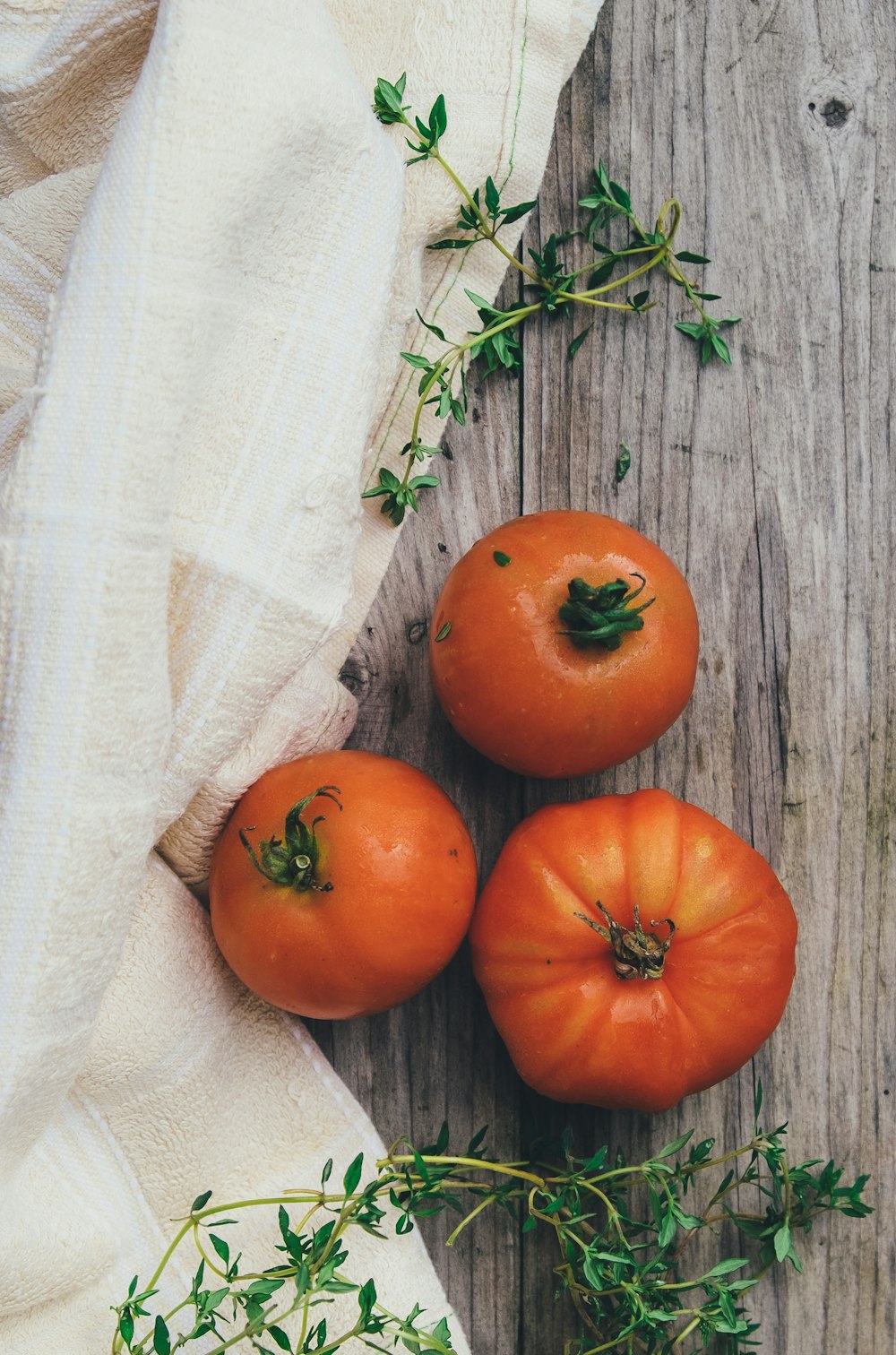 three orange tomato fruits