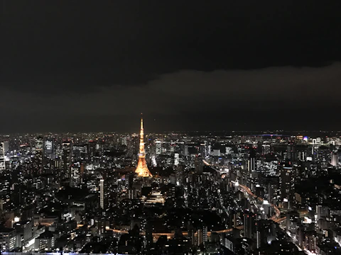 A sprawling Minecraft cityscape with tall buildings and streets lit by lanterns.