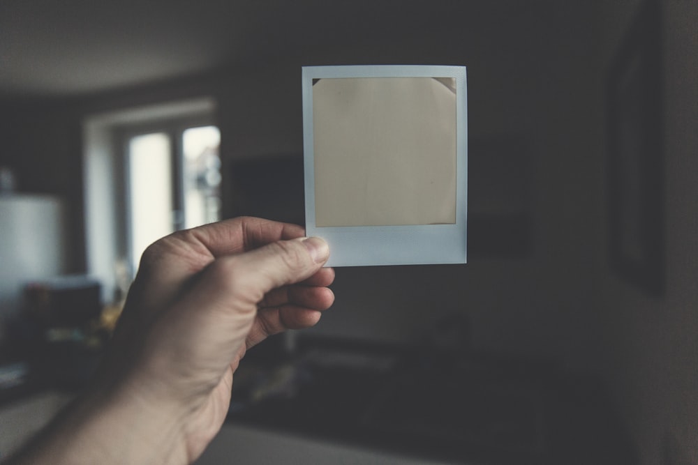 person holding white paper