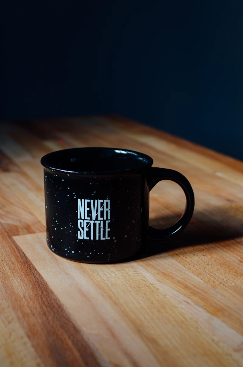 A quiet desk with a cup of coffee in soft morning light