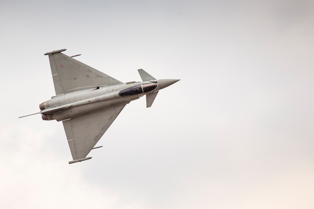 white fighting jet flying in mid-air, Eurofighter Typhoon demo display team during Air Show