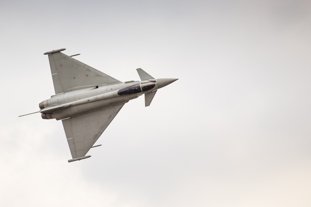 white fighting jet flying in mid-air, Eurofighter Typhoon demo display team during Air Show