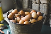 A basket overflowing with freshly laid eggs on a rustic wooden table, highlighting farm freshness.