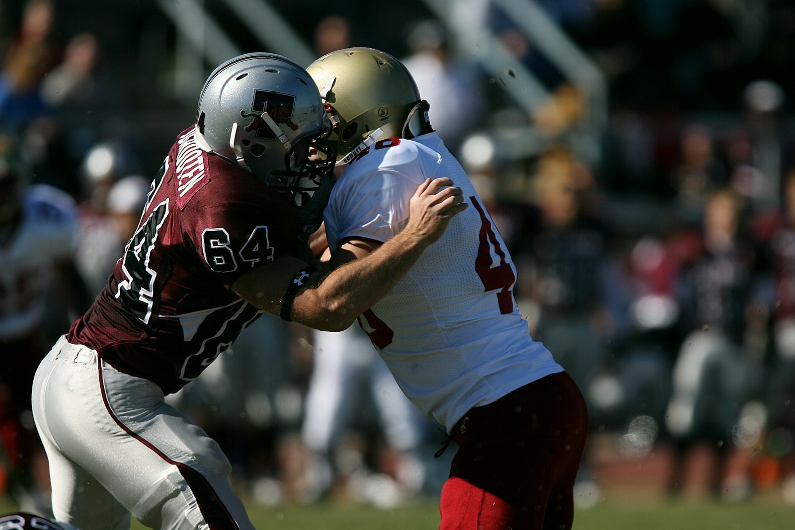 Two college football players battling for position at the line