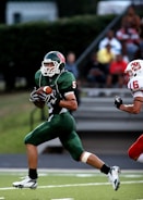 man in green 5 American football jersey holding ball