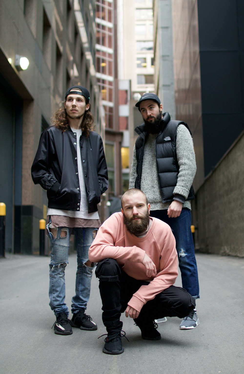 a group of men standing next to each other on a street