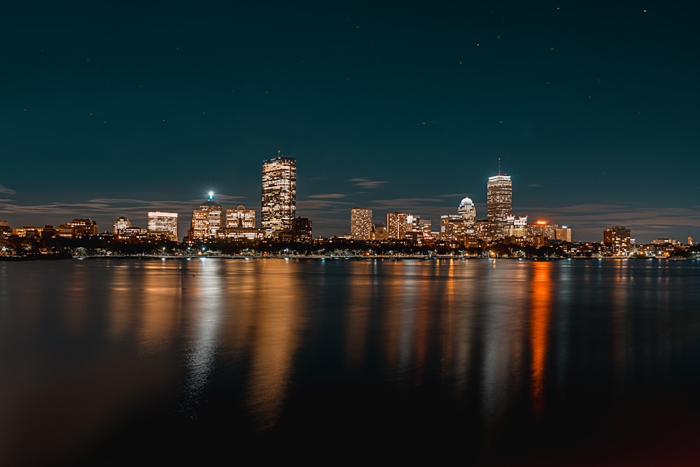 city buildings next to body of water during nighttime