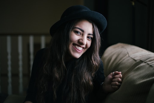 woman smiling while sitting on couch