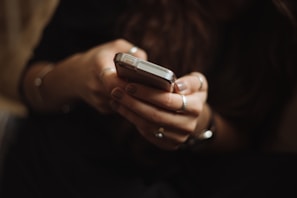 person using smartphone to schedule appliance repair