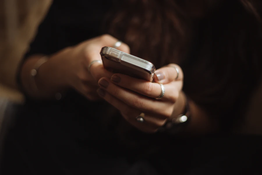 A person sending a message on a smartphone.