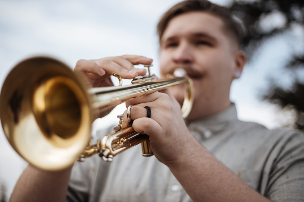 man playing trumpet outdoors