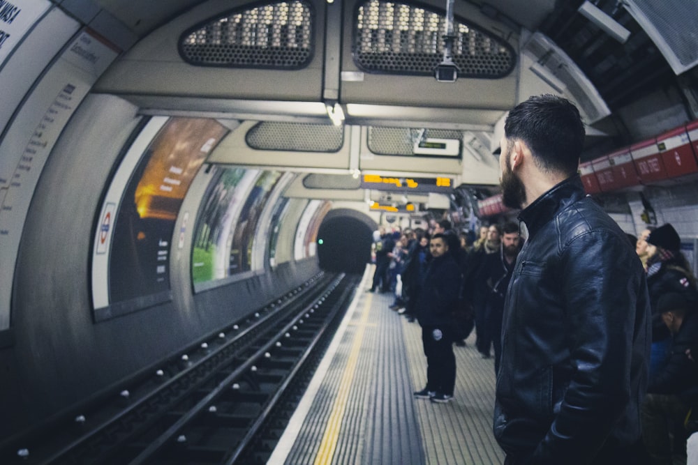 people standing in train station