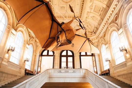 building interior with bi-plane ornament hanging inside in Musée des Arts et Métiers France