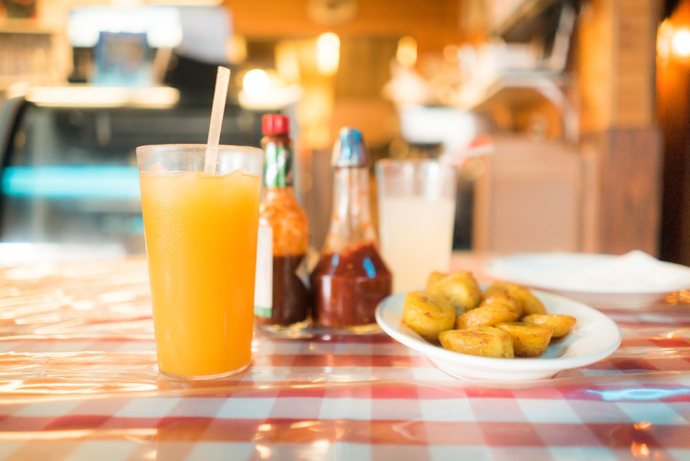 shallow focus photography of juice in glass on table