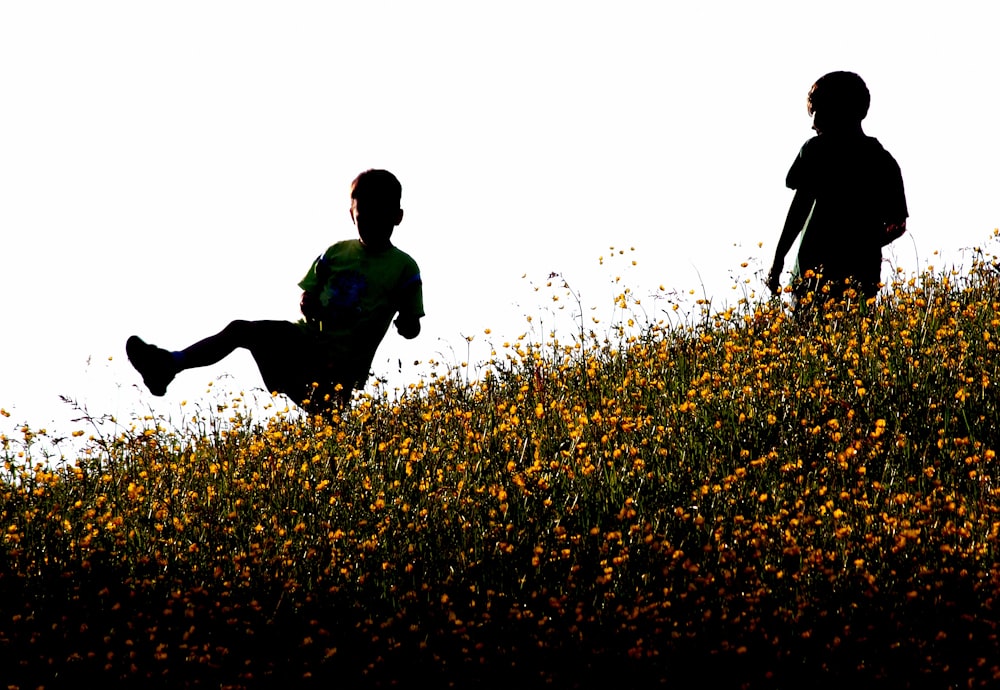 two boys standing on flowers